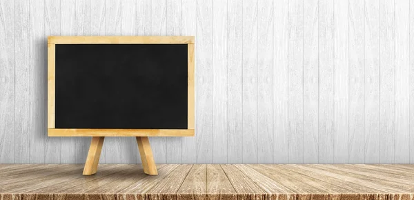 Blackboard menu with easel on wooden table with white wooden wal — Stock Photo, Image
