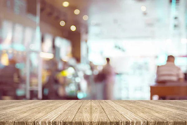 Empty wood plank table top with blur customer in coffee shop wit — Stock Photo, Image