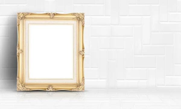Empty golden vintage frame at white clean tile wall and floor ba