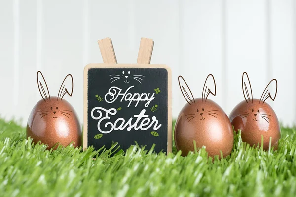 Happy easter with doodle rabbit on blackboard and rose gold colo