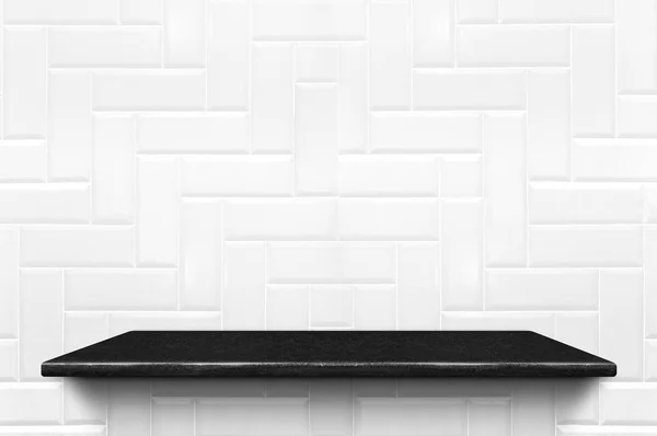 Empty black marble shelf at white ceramic tile wall pattern back