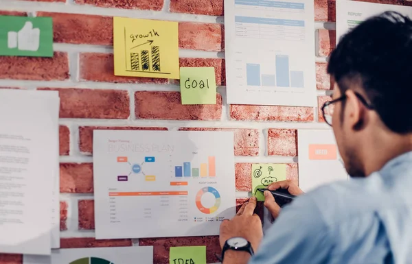 Asian man creative director designer looking at data chart and f — Stock Photo, Image