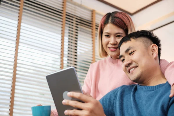 Asian Couple Watching Video Live Tablet Sofa Living Room Home — Stock Photo, Image