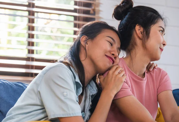 Friend ask for forgiveness with her girlfriend sitting on sofa at home.Lebsian LGBTQ lifestyle concept