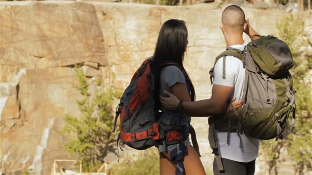 Couple of hikers looking through the binoculars — Stock Video