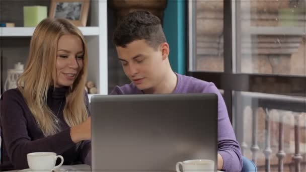 Couple looks at the laptop at the cafe — Αρχείο Βίντεο