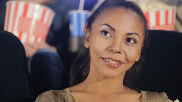 Woman smiles at the movie theater — Stock Video