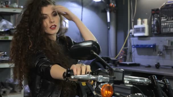 Female biker shakes her hair on the motorcycle — Stock Video