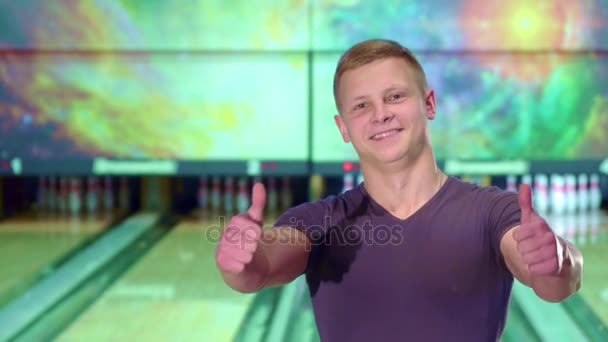 Homem mostra seus polegares para cima na pista de bowling — Vídeo de Stock