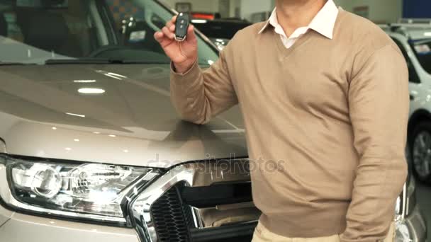 Elegante hombre recoge las llaves del coche y muestra los pulgares hacia arriba — Vídeo de stock