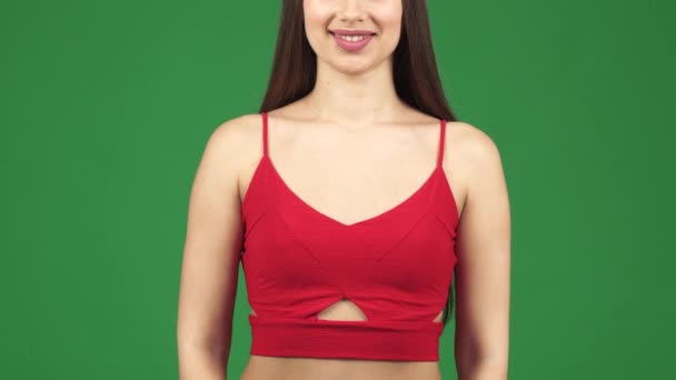 Bijgesneden studio shot van een vrouw die lacht bedrijf boodschappentassen duimen opdagen — Stockvideo