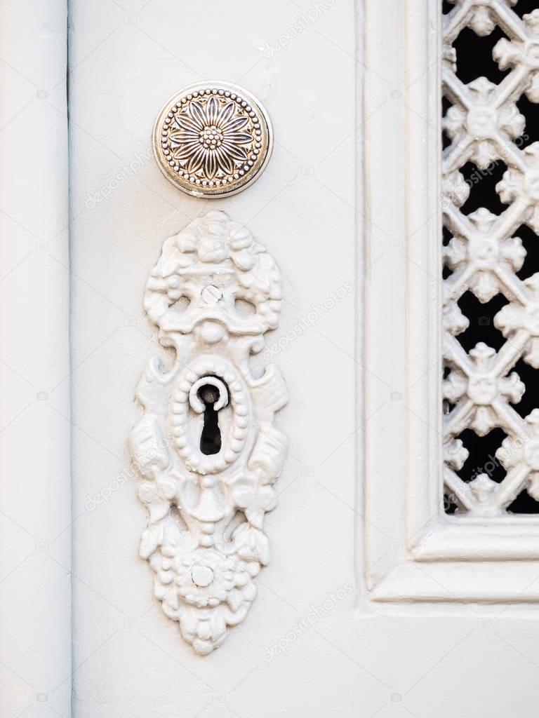 Keyhole and handle in white door