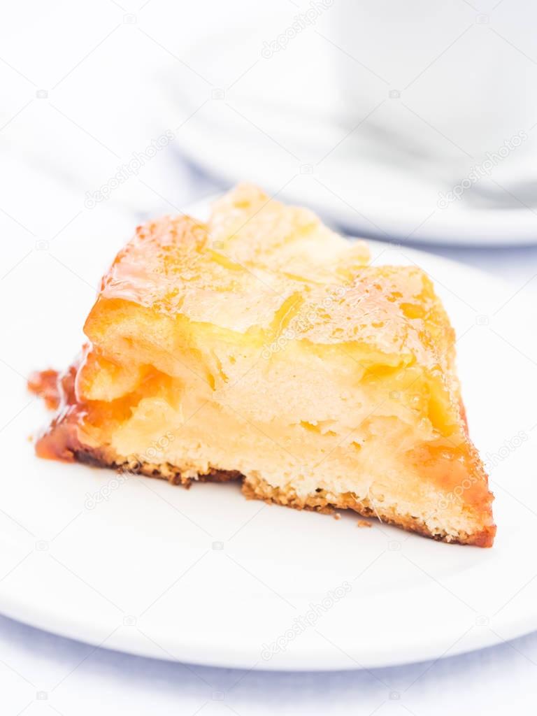 Slice of typical pineapple cake from Azores on white plate 