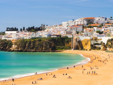 ALBUFEIRA, PORTUGAL - MARCH 26, 2018: View of the city and the beach of Albufeira, one of the most popular summer destinations in Portugal. clipart