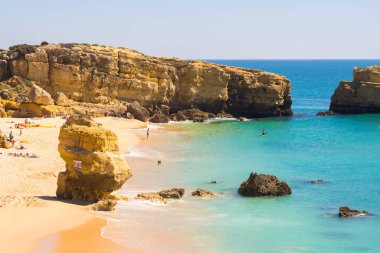 beautiful rocky Sao Rafael beach or Praia de Sao Rafael with clean blue water in Algarve region, Portugal.  clipart
