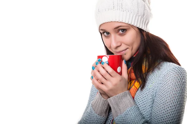 Beautiful brunette girl is enjoying hot drink — Stock Photo, Image