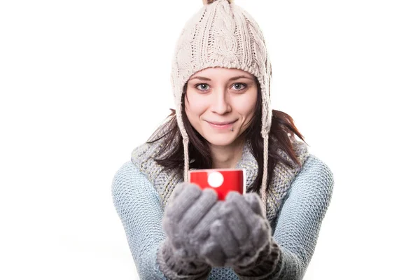 Όμορφη happy χαμογελαστή γυναίκα ντυμένη με ρούχα χειμώνα κρατώντας ένα ζεστό φλιτζάνι καφέ στο σπίτι. απομονωμένα σε λευκό φόντο — Φωτογραφία Αρχείου