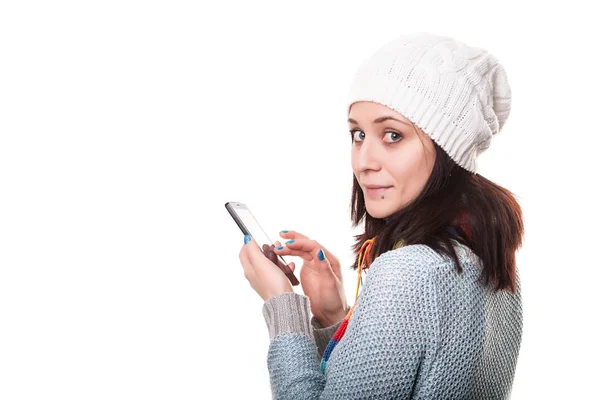 Девушка переписывается на мобильном. Изолированный над белым Лицензионные Стоковые Фото