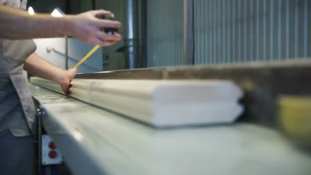 Carpenter working with tape measure,marking wooden desk — Stock Video