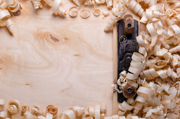  wood shavings on a wooden background with tools
