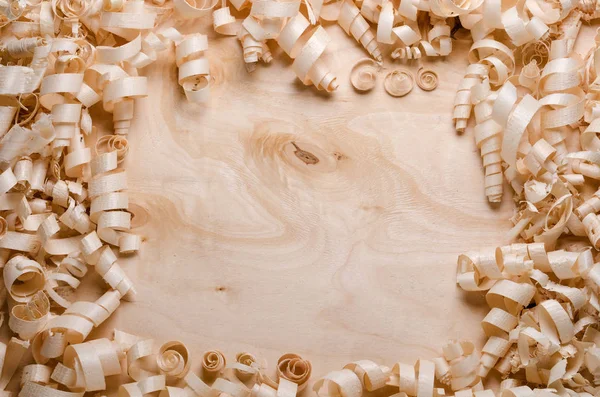 Wood shavings on a wooden background — Stock Photo, Image