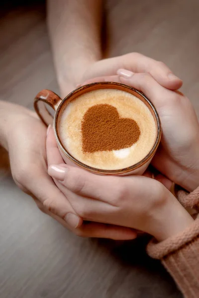 Lovers hold coffee with heart in hands — Stock Photo, Image