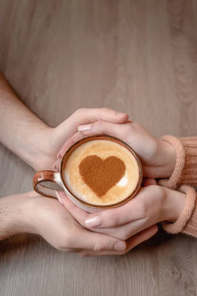 Lovers hold coffee with heart in hands — Stock Photo, Image