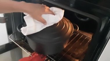 Baking bread in dutch oven; uncovering the baking pot after 20 minutes baking; 10 minutes more to bake.