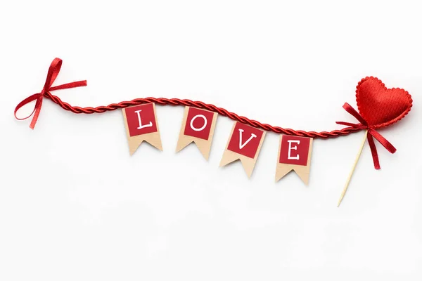 Creative valentines concept photo of flags with love sign and heart on the rope on white background. — Stock Photo, Image