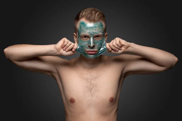 Man with cleaning clay facial mask — Stock Photo, Image