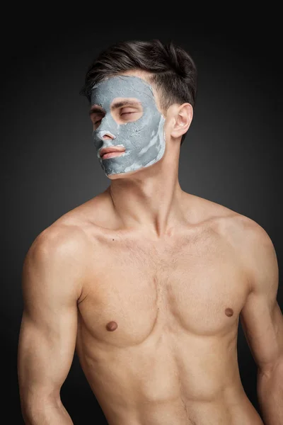 Man with cleaning clay facial mask — Stock Photo, Image