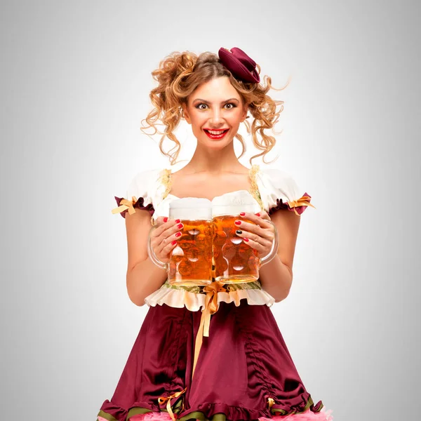 Waitress holding beer mugs — Stock Photo, Image