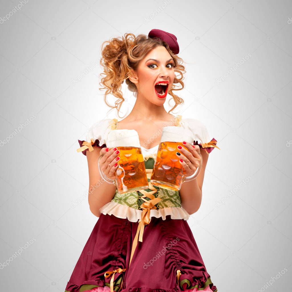 Waitress holding beer mugs