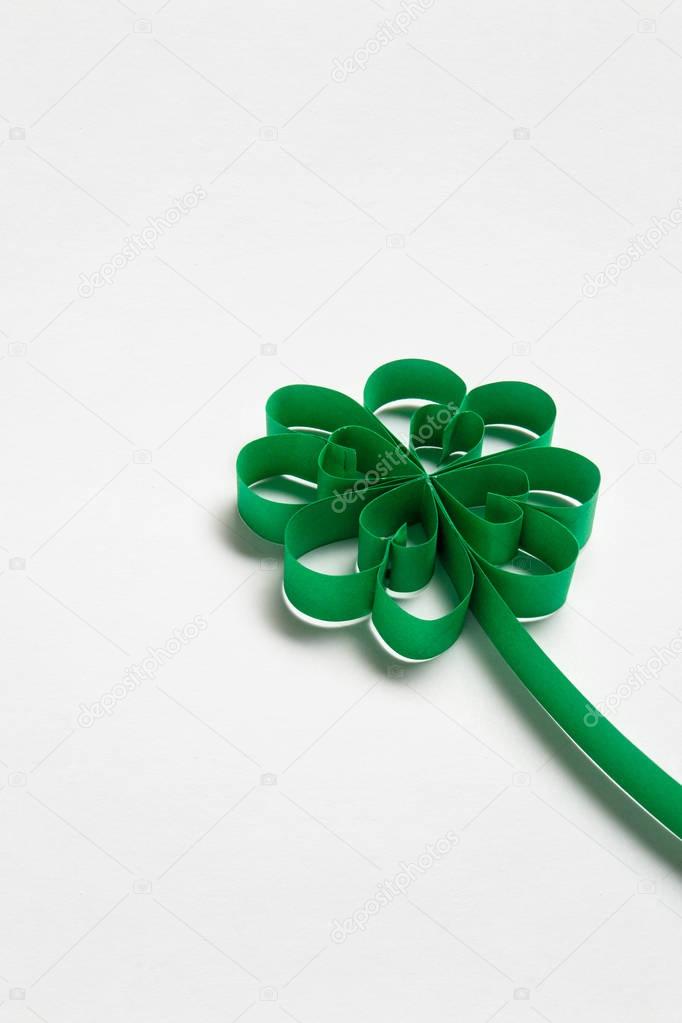 Good luck. Creative St. Patricks Day concept photo of a shamrock made of paper on white background.