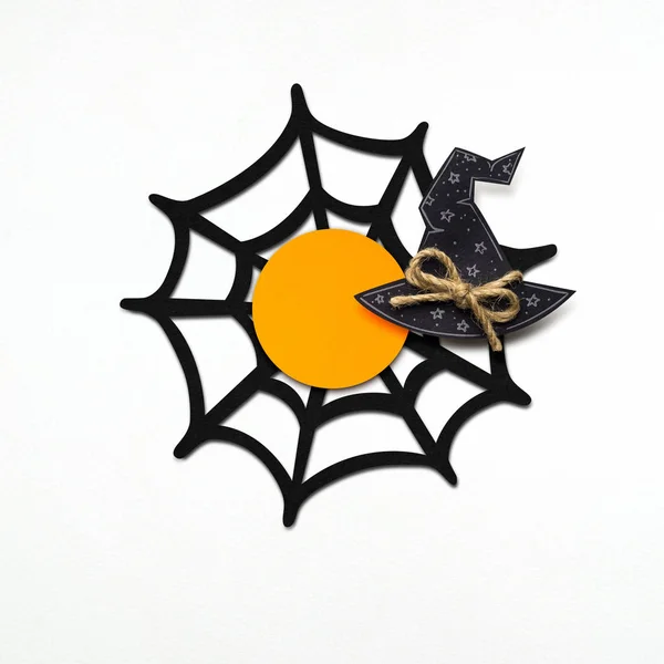 Happy halloween.  Creative concept photo of spider web and witchs hat on white background. — Stock Photo, Image