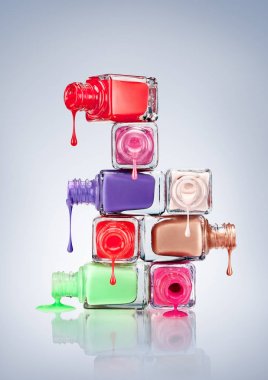 Nail polish dripping from stacked bottles. clipart