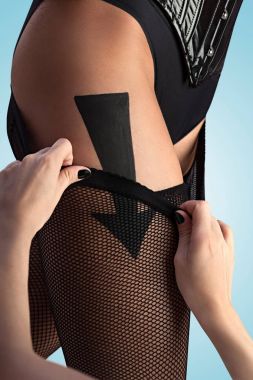 A beautiful sexy girl taking off her fishnet pantyhose according to the arrow sign. clipart