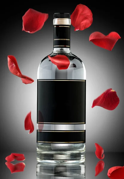 Photo Luxury Alcohol Bottle Falling Rose Leaves — Stock Photo, Image
