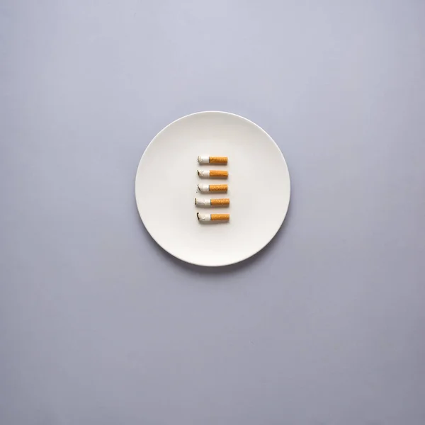 Creative Concept Photo Kitchenware Hand Painted Plate Cigarettes Grey Background — Stock Photo, Image