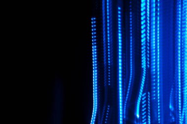 Long exposure light painting photography of abstract lines with blue light isolated on black background. Wallpaper. 