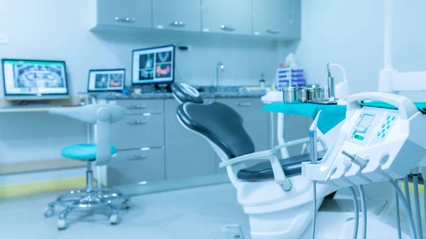 Equipment for dentists, Modern dental practice. Dental chair and other accessories used by dentists in blue, medic light