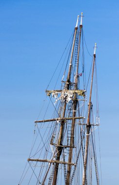 Mavi gökyüzüne karşı yelkenli gemi direği