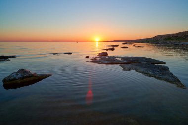 Gün batımında taşlarla Denizi'nin kıyısında. Hazar Sea.The Hazar Denizi kıyısında alanına göre dünyadaki en büyük kapalı iç su organıdır.