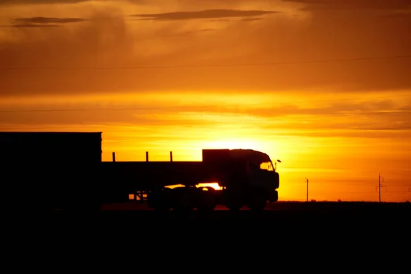 Silhouette of a moving truck at sunset.A truck is a motor vehicle designed to transport cargo. Trucks vary greatly in size, power, and configuration.