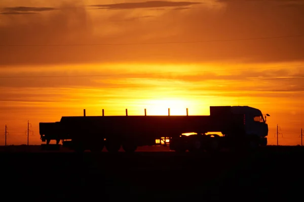 Silhouette of a moving truck at sunset.A truck is a motor vehicle designed to transport cargo. Trucks vary greatly in size, power, and configuration.
