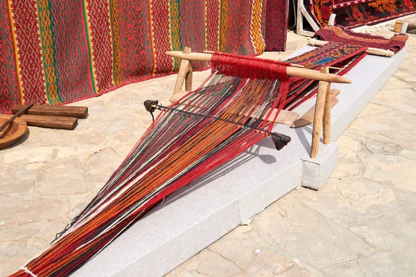 Weaving machine for carpet.Weaving machine is the main weaving machine, equipment or device for manufacturing all kinds of pile, smooth, woven clothes and carpets: linen, hemp, cotton, silk and wool.
