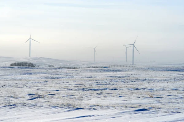 Wind power plants in winter.Wind power is the use of air flow through wind turbines to mechanically power generators for electric power. A wind farm is a group of wind turbines in the same location used for production of electric power.