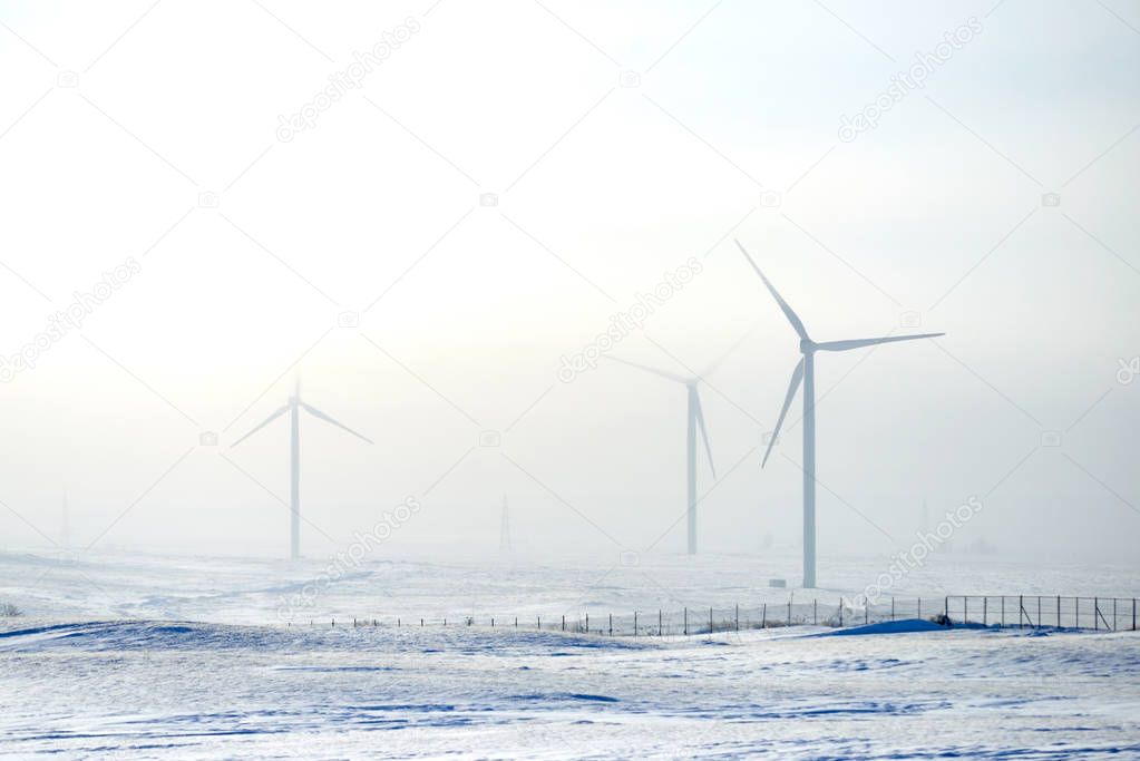 Wind power plants in winter.Wind power is the use of air flow through wind turbines to mechanically power generators for electric power. A wind farm is a group of wind turbines in the same location used for production of electric power.