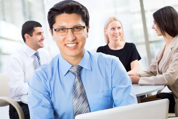 Businessman with his colleagues behind him — Stock Photo, Image