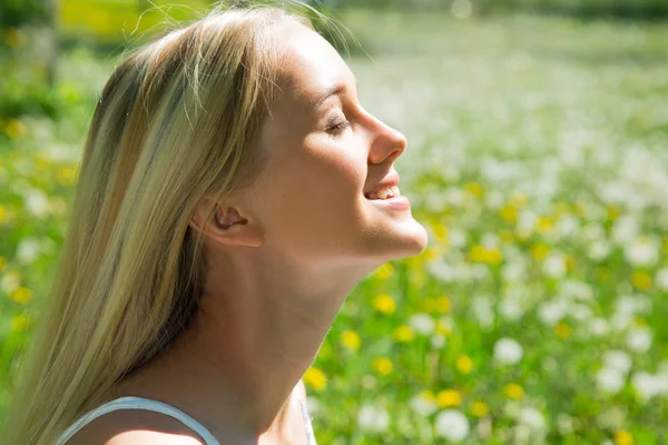 Woman among dandelions — Stock Photo, Image